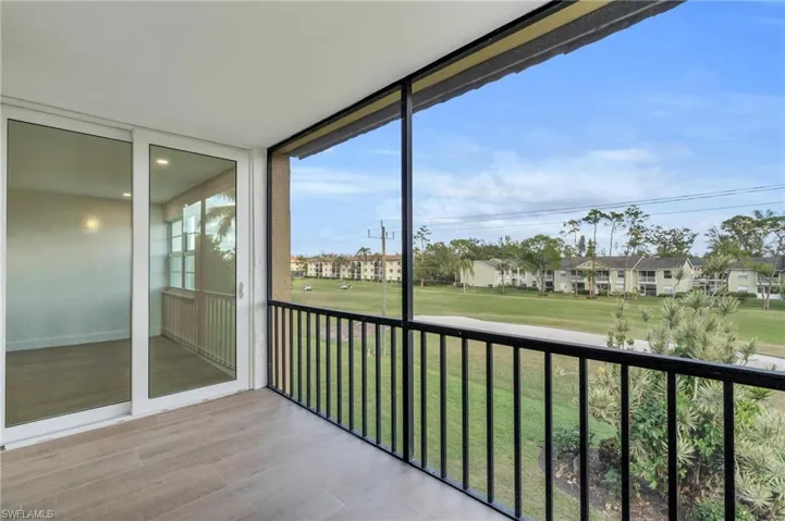 Balcony featuring a sunroom and golf course view