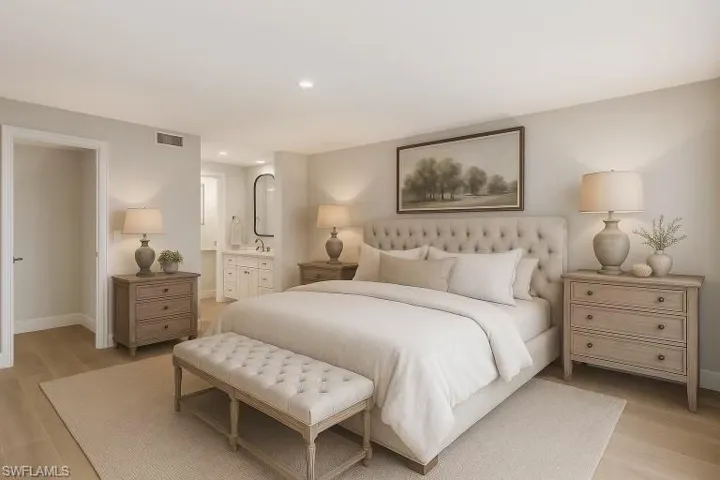 Bedroom featuring light wood-style flooring, recessed lighting, and ensuite bath