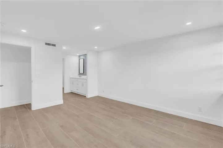 Unfurnished bedroom featuring recessed lighting, light wood-style floors, and connected bathroom