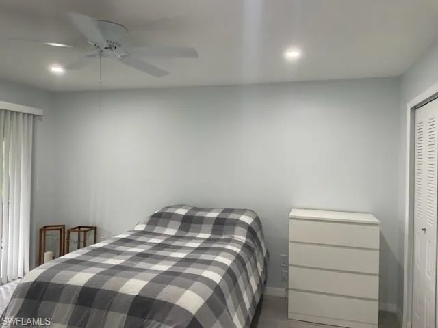 Bedroom with recessed lighting, baseboards, ceiling fan, a closet, and wood finished floors
