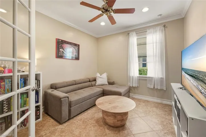 Sitting room with ornamental molding, a ceiling fan, recessed lighting, and light tile patterned flooring