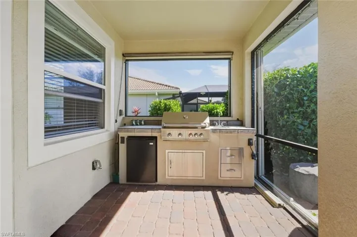 View of patio / terrace with exterior kitchen and a sunroom