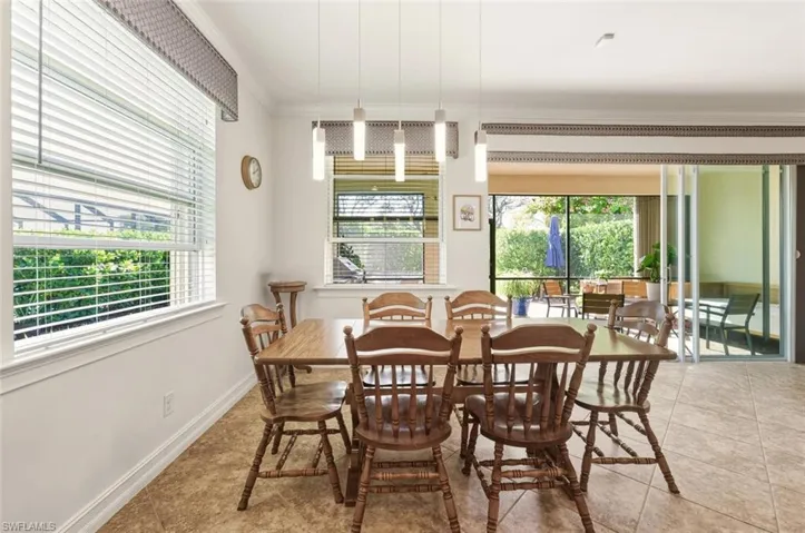 Dining room featuring crown molding and light tile patterned floors