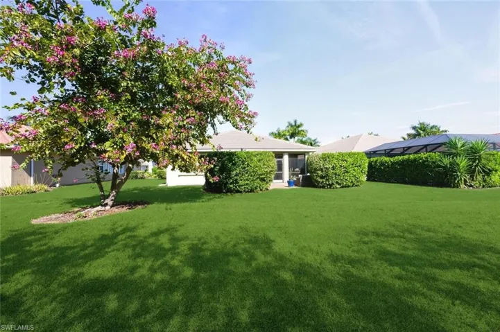 View of green lawn with a sunroom