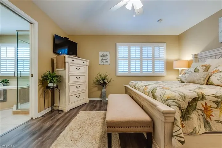 Primary Bedroom showcasing vaulted ceiling and decorative colonial shutters