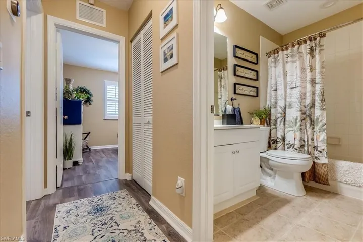 Hallway showing secondary bathroom leading into both secondary bedrooms
