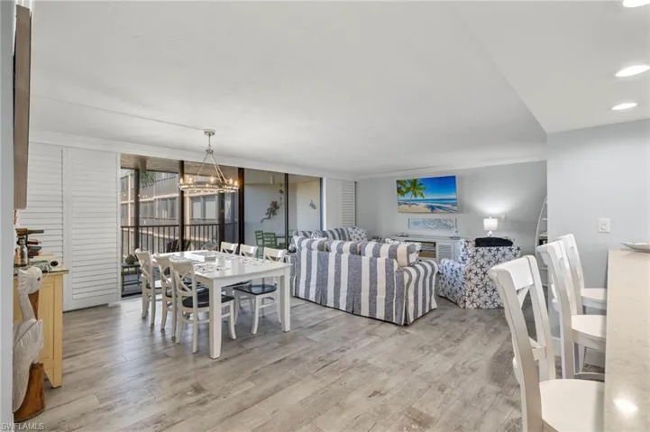 Dining space with light hardwood / wood-style flooring and a chandelier