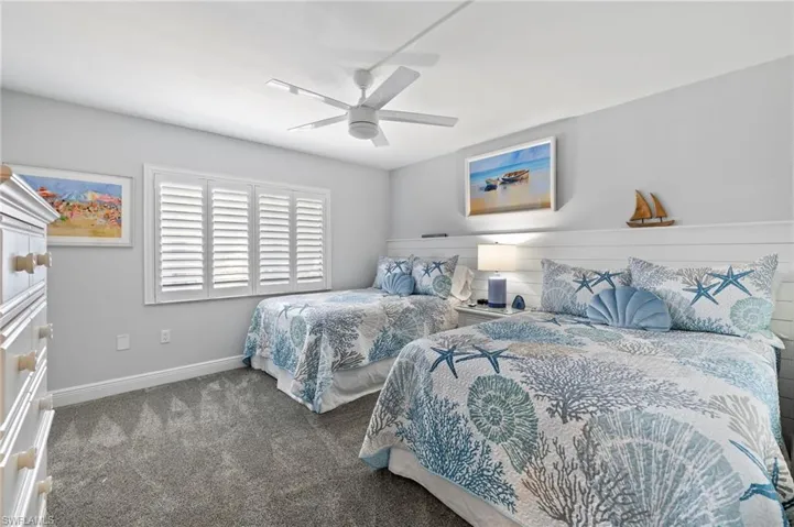 Carpeted bedroom with ceiling fan
