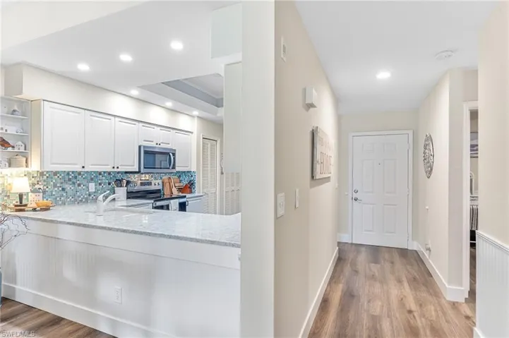 breakfast bar backside of kitchen and looking to front door