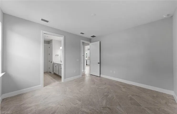 Unfurnished bedroom featuring ensuite bathroom