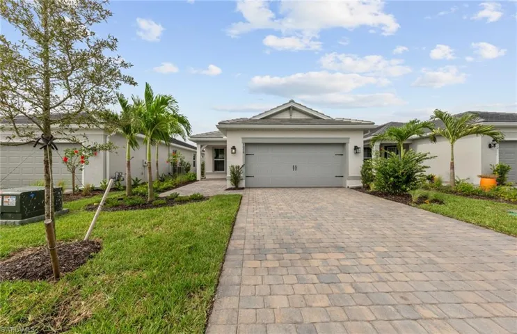 Single story home with a front lawn and a garage