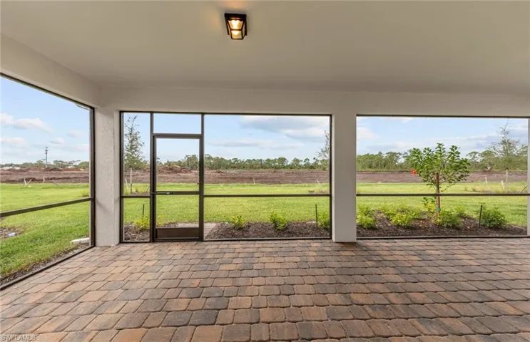 Unfurnished sunroom featuring a rural view