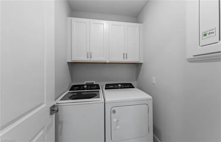 Clothes washing area with washing machine and dryer and cabinets