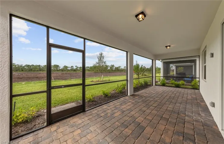 Unfurnished sunroom with a healthy amount of sunlight and a rural view