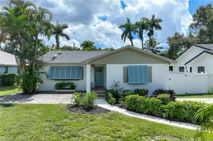 Single story home with stucco siding and roof with shingles