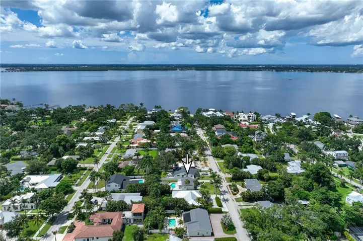 Aerial perspective of suburban area with a large body of water