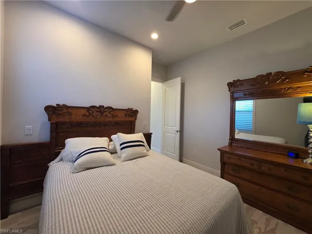 Bedroom with ceiling fan and recessed lighting