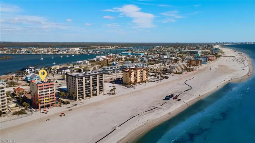 Birds eye view of property featuring a view of the beach and a water view