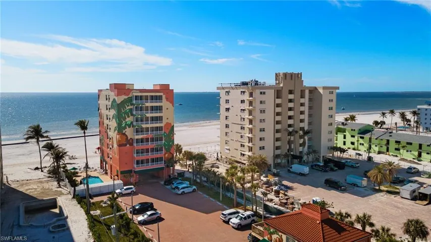 Birds eye view of property featuring a water view and a beach view