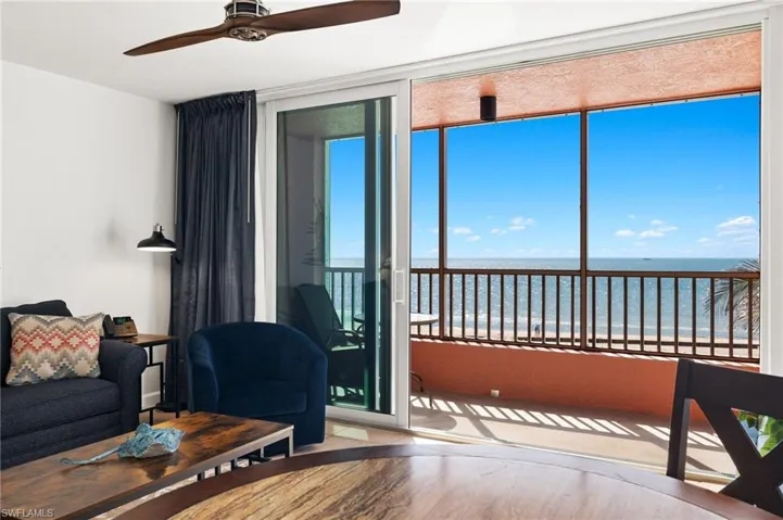 Living room featuring hardwood / wood-style floors, a healthy amount of sunlight, and a water view