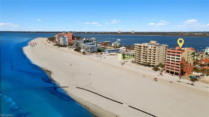 Birds eye view of property featuring a view of the beach and a water view