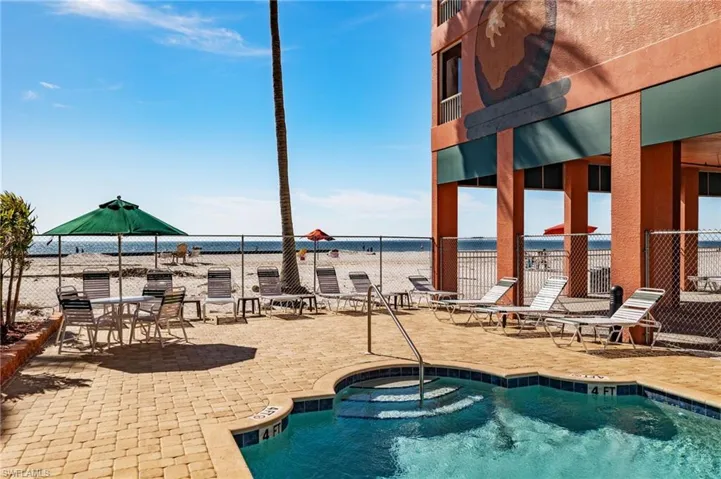 View of pool with a water view and a patio area
