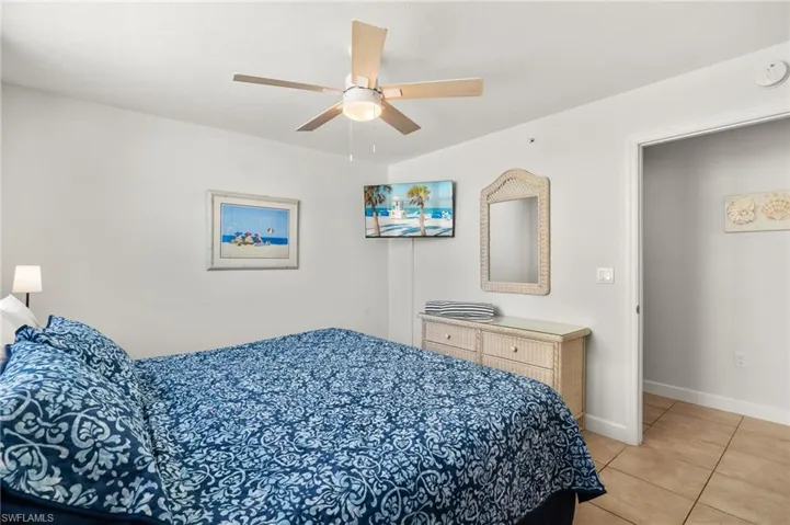 Bedroom featuring light tile patterned floors and ceiling fan