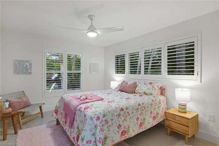 Bedroom with ceiling fan and carpet