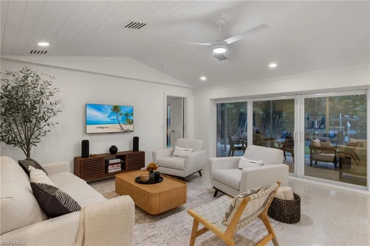 Living room with wooden ceiling, vaulted ceiling, and ceiling fan