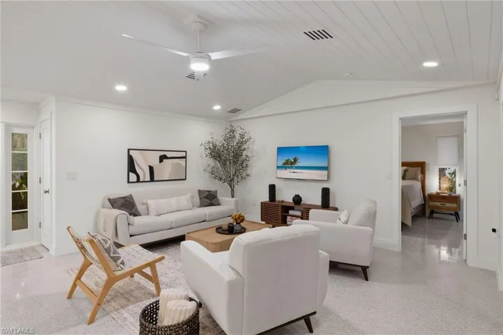 Living room featuring wooden ceiling, lofted ceiling, and ceiling fan
