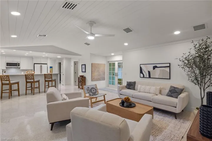 Living room with wooden ceiling, lofted ceiling, and ceiling fan