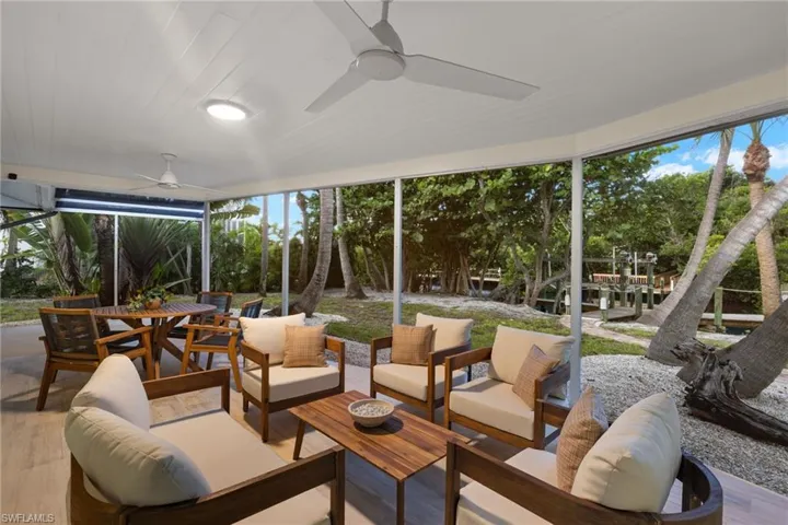 Sunroom / solarium featuring wooden ceiling, a healthy amount of sunlight, and ceiling fan