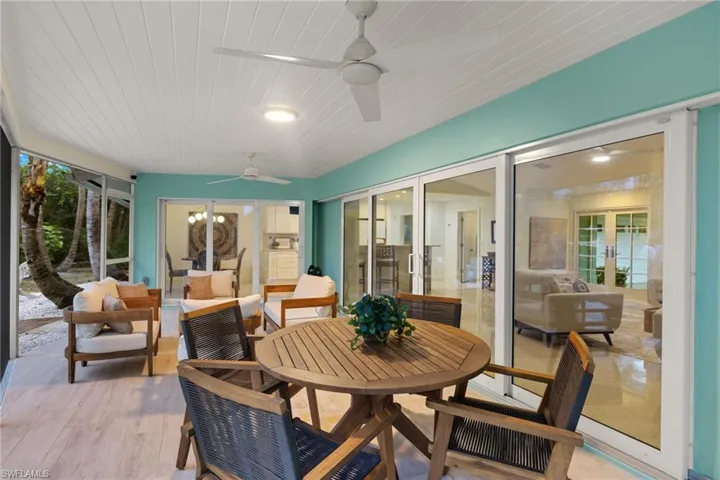 Dining area with ceiling fan, light wood-type flooring, and french doors