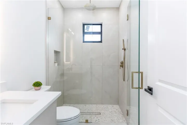 Full bathroom with a marble finish shower and vanity