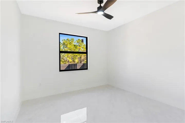 Unfurnished room featuring baseboards and a ceiling fan