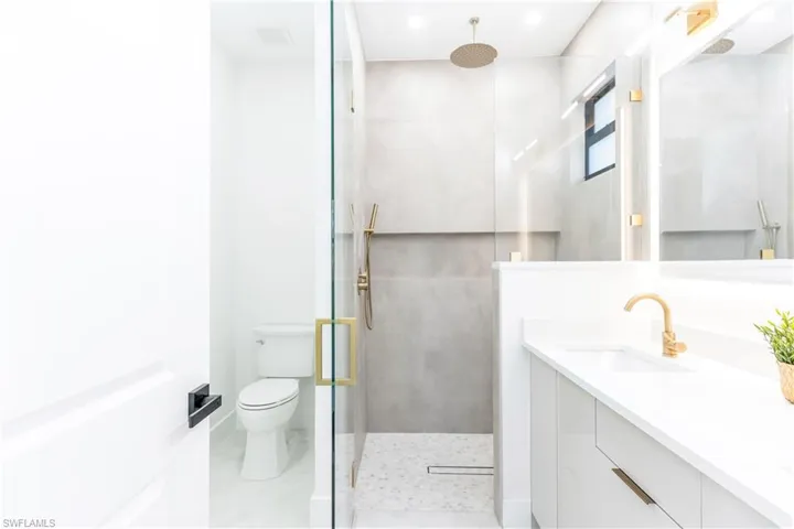 Full bath featuring vanity, a stall shower, and recessed lighting