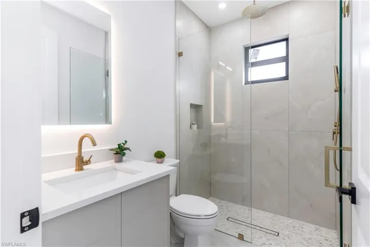 Bathroom with vanity and a stall shower