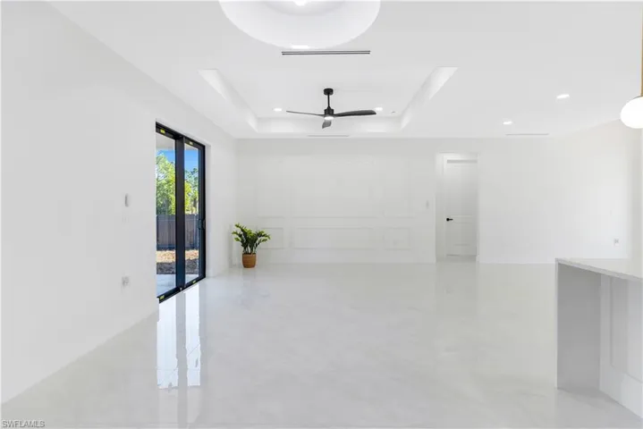 Dining room featuring ceiling fan, a raised ceiling, and recessed lighting