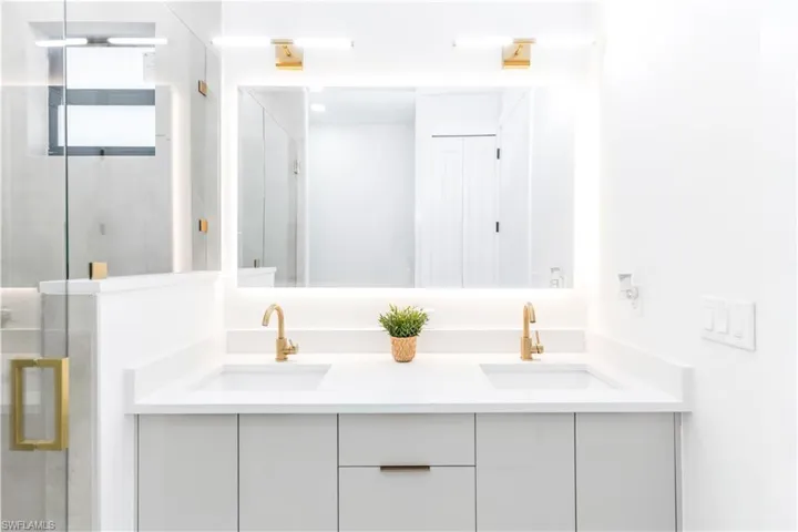 Bathroom with double vanity and a shower stall