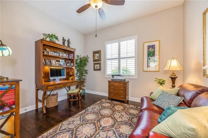 Office featuring dark wood-type flooring and ceiling fan