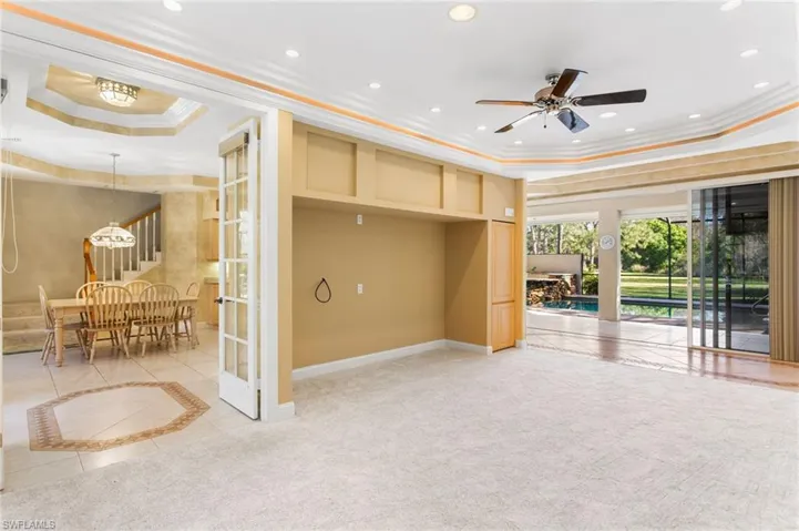 Carpeted interior space featuring a built-in media niche, ceiling fan, and recessed lighting
