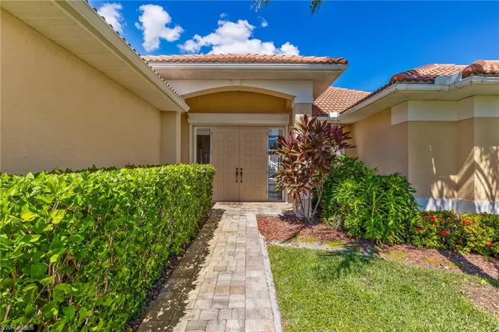 Doorway to property with a tiled roof and stucco siding