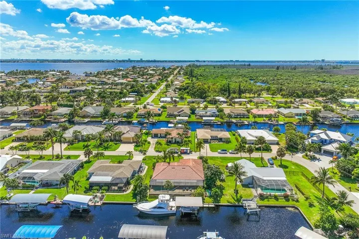 Aerial perspective of suburban area featuring a nearby body of water