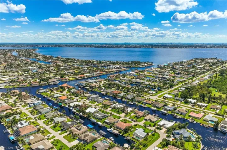 Aerial perspective of suburban area with a nearby body of water