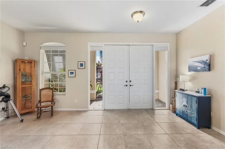 Foyer with baseboards and light tile patterned floors