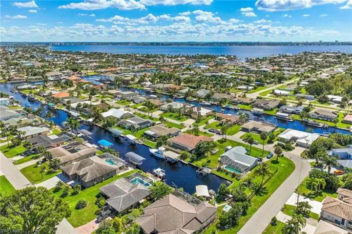 Aerial perspective of suburban area with a large body of water