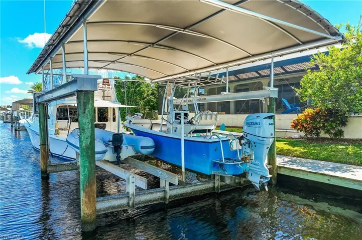 Dock with boat lift and a water view