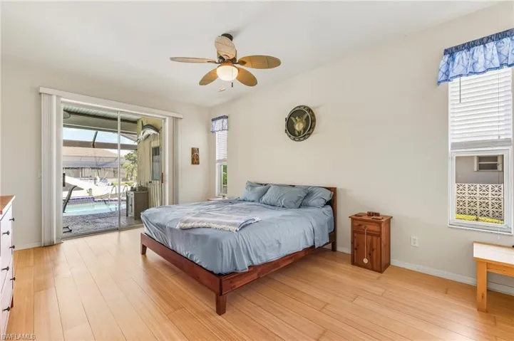 Bedroom with light wood-style flooring and multiple windows