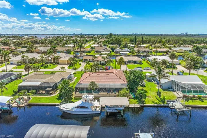 Aerial perspective of suburban area with a large body of water