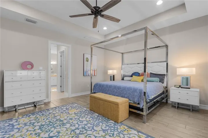 Primary Bedroom featuring wood finish floors, ceiling fan, and recessed lighting